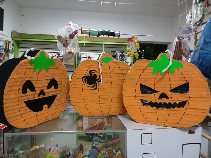 Varias piñatas de calabaza con distintas caras