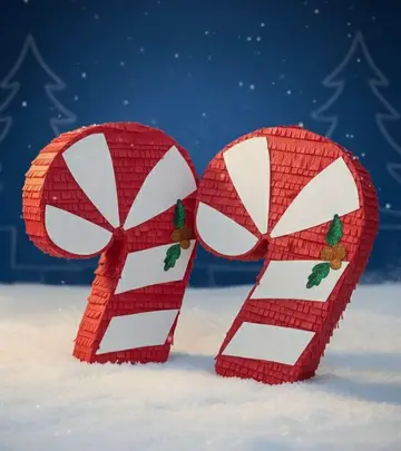 Dos piñatas de bastón de caramelo rojo y blanco