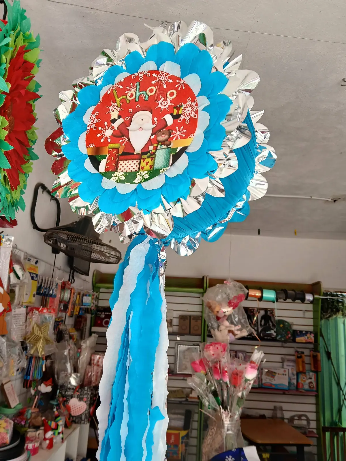 Round Christmas piñata with ribbons