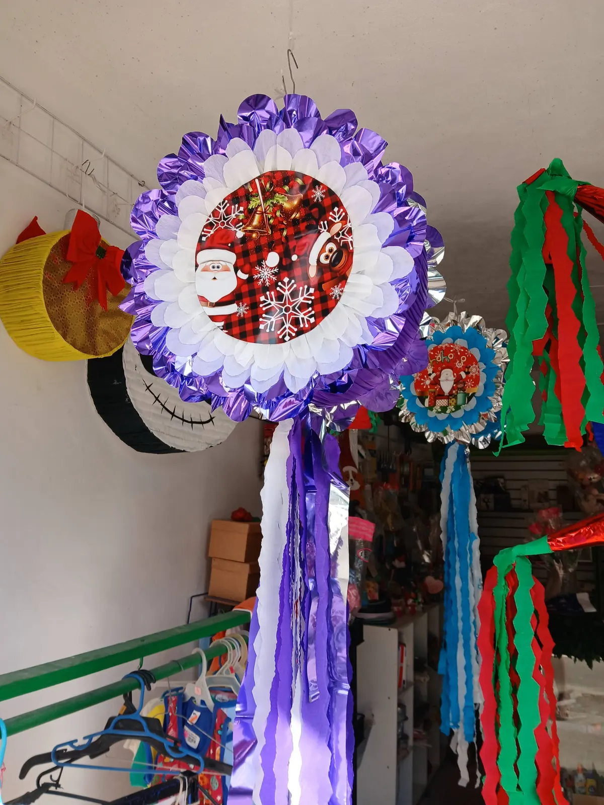 Round Christmas piñata with ribbons